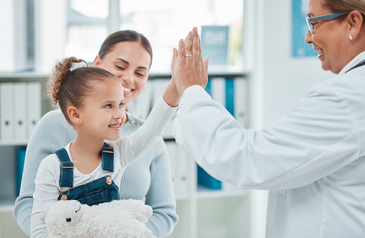 Shot of a little girl giving a doctor a high five