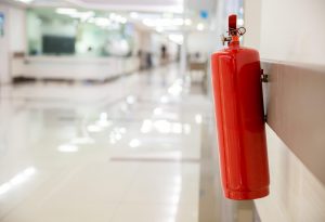 hospital fire extinguisher hanging on the wall